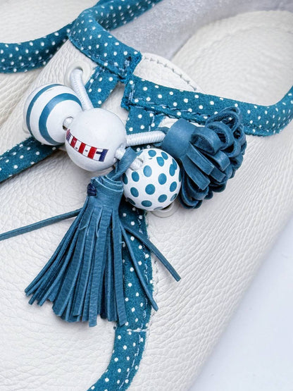 Leather and wooden decorations close up aqua shoes