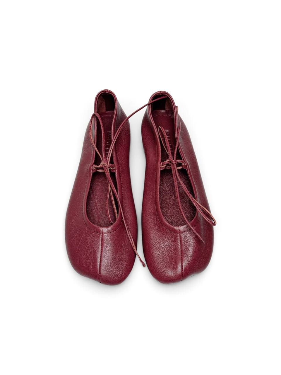 Garnet ballet flats showing anatomical shape and leather tie detail