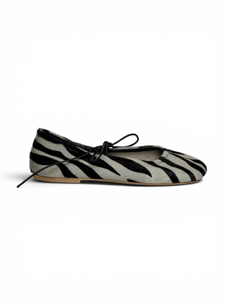 Side profile of designer zebra leather ballet flats