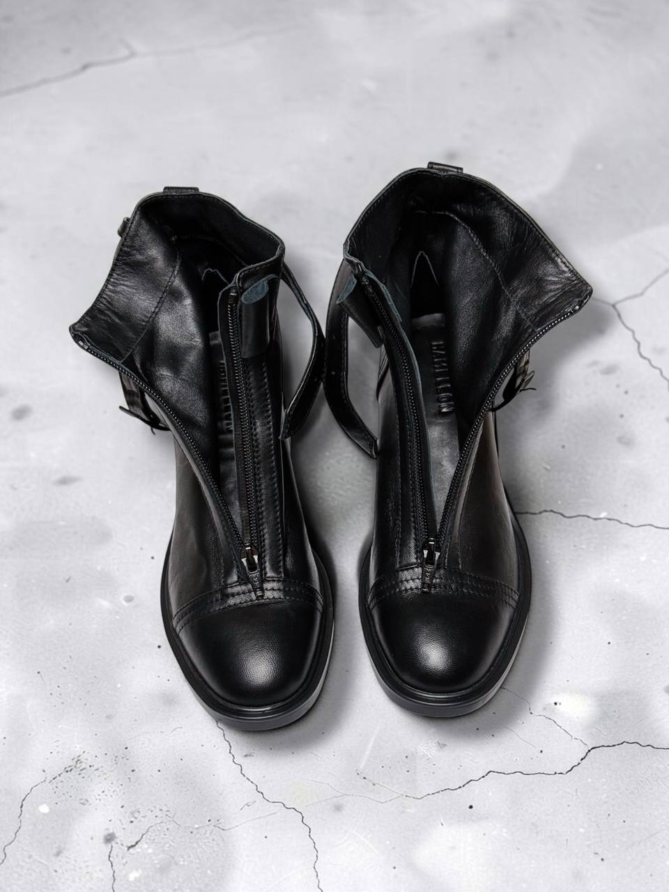 Black boots showing molded polyurethane soles and block heels