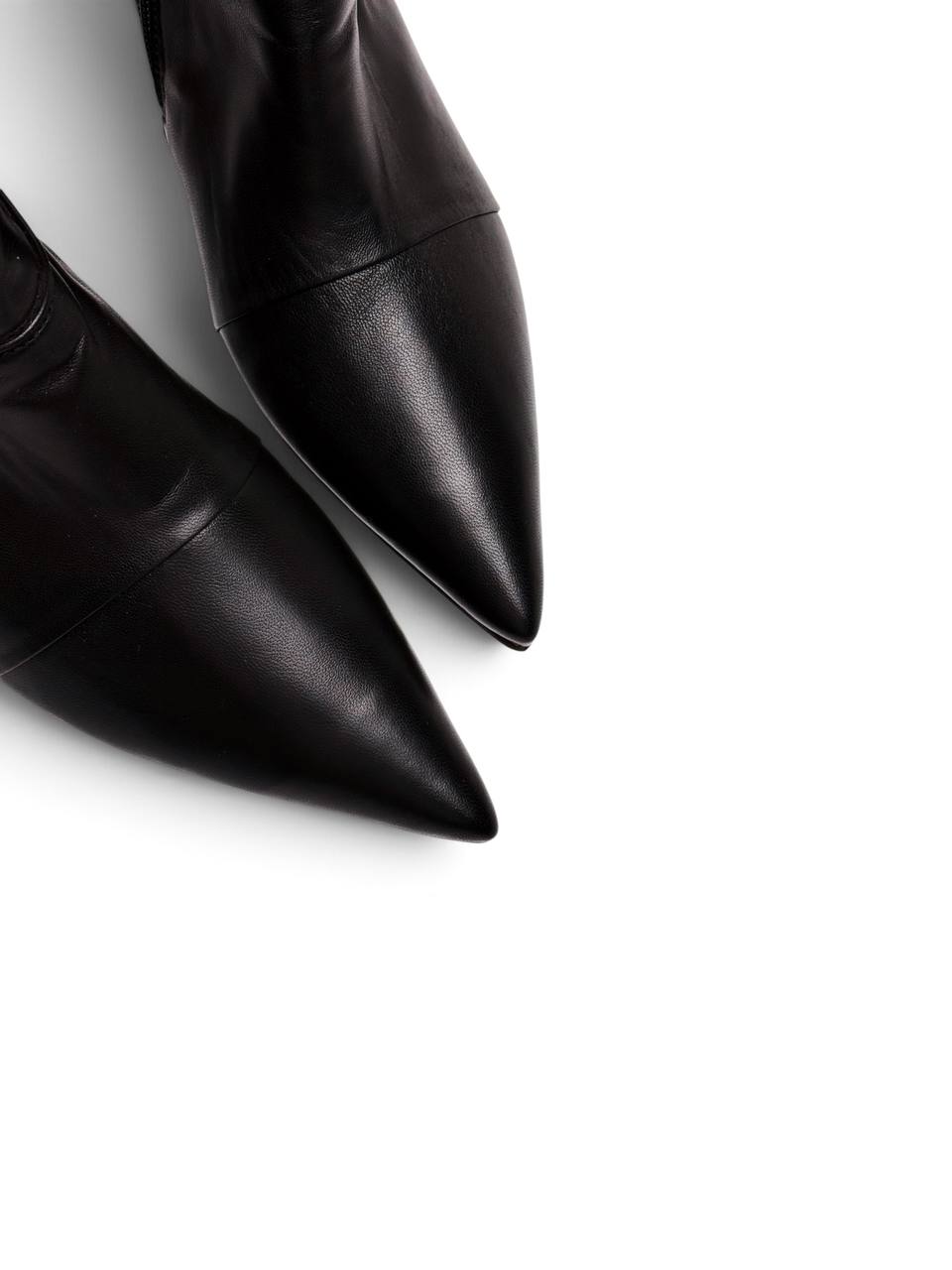 Close-up of pointed toes on black leather ankle boots Cindy