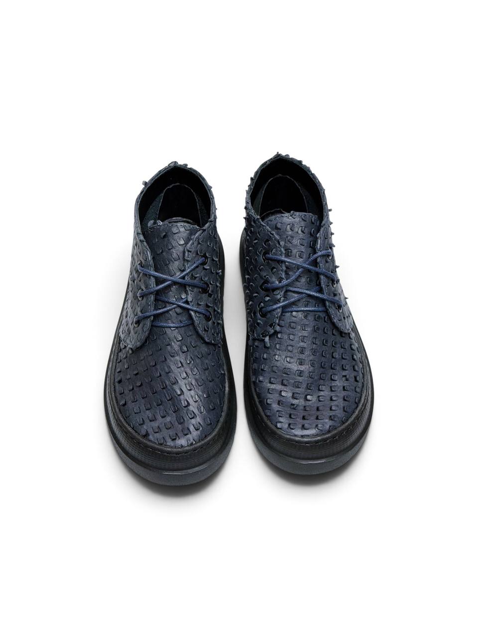Front view of navy leather desert boots with textured uppers.