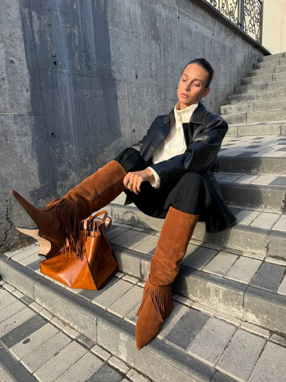 Brown suede fringe boots styled with black trousers and leather jacket