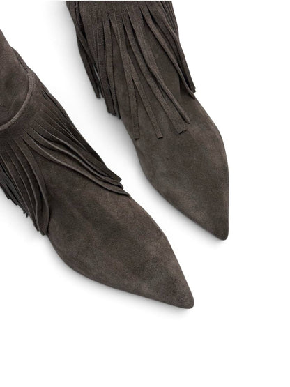 Close-up of pointed toes and soft taupe suede texture