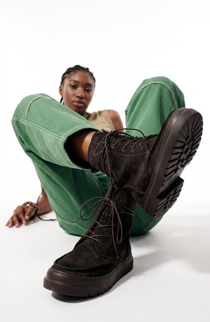 Black HAMELEON handcrafted lace-up boots with a chunky lug sole worn by a model