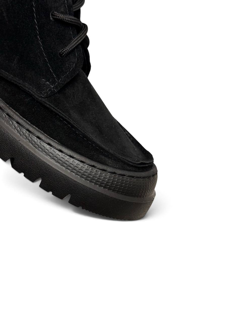 Close-up of black suede toe and textured EVA sole