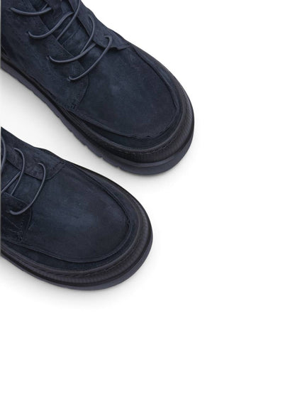 Blue-black suede boot profile with side zipper detail
