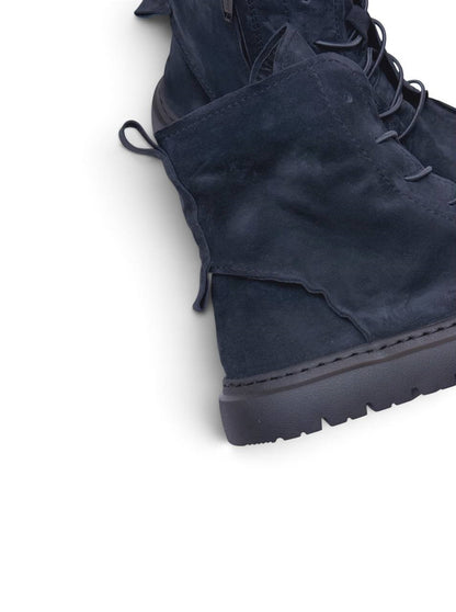 Rounded moc-toe construction in dark blue-black suede