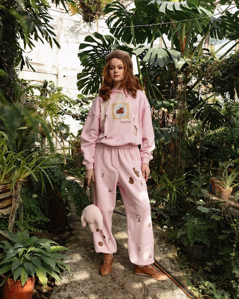 Woman wearing brown boots in a greenhouse