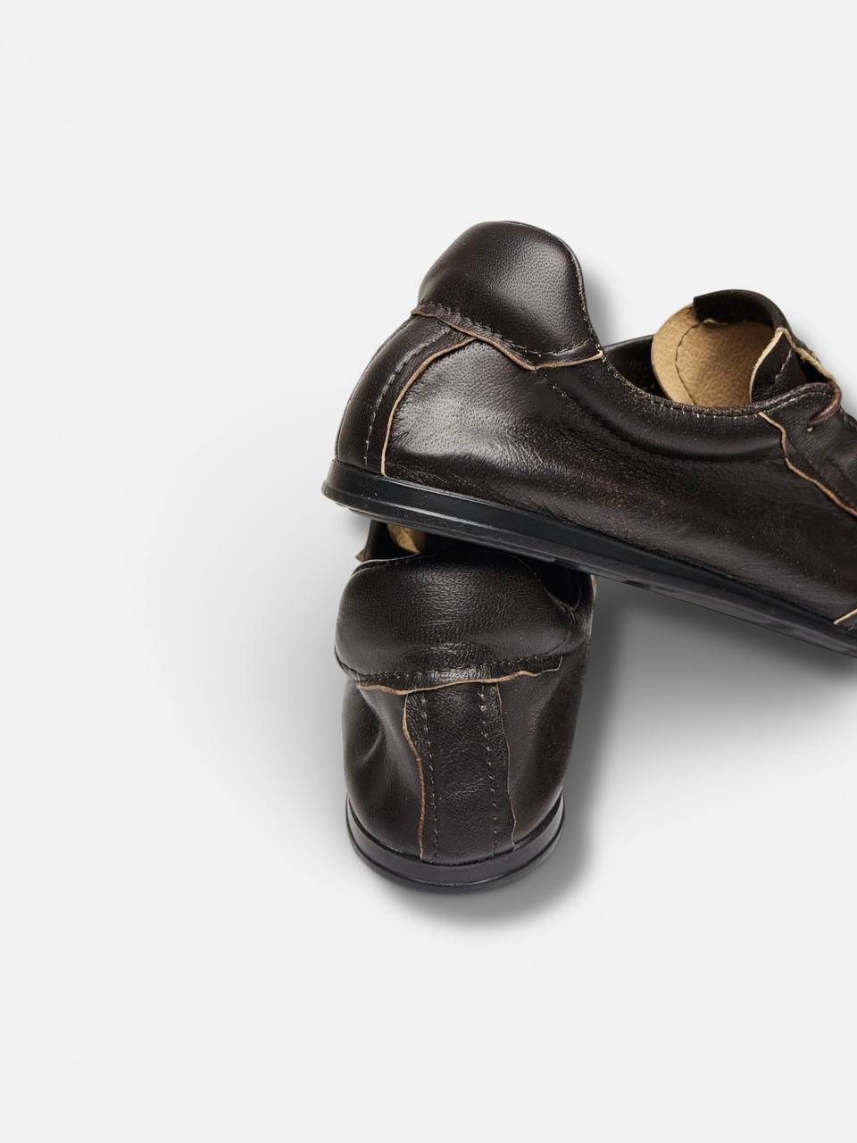 Rear view showing the clean heel shape and soft leather construction of the FLOW Terra.