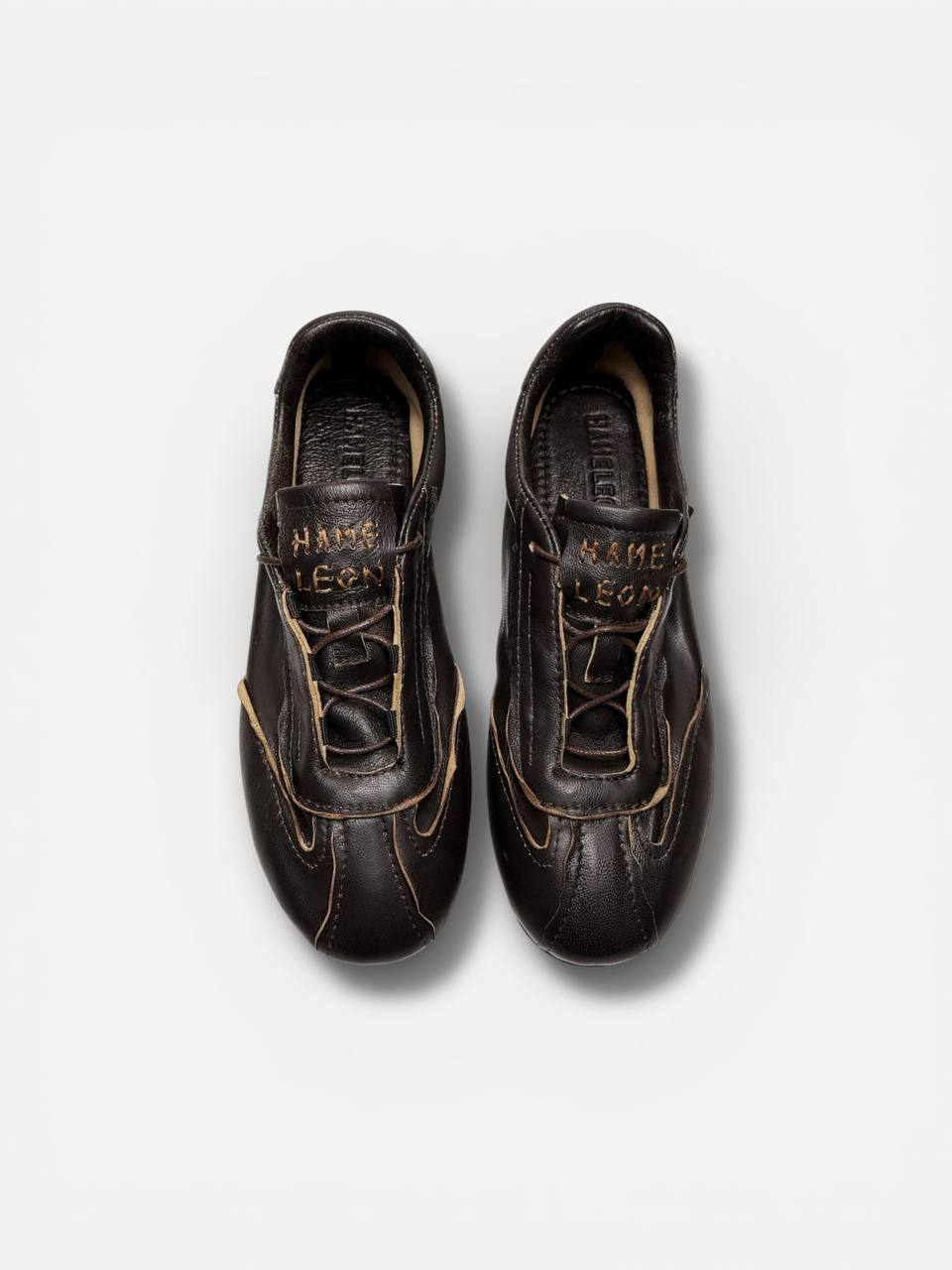 A pair of FLOW Terra leather sneakers in dark brown with a clean handcrafted finish.