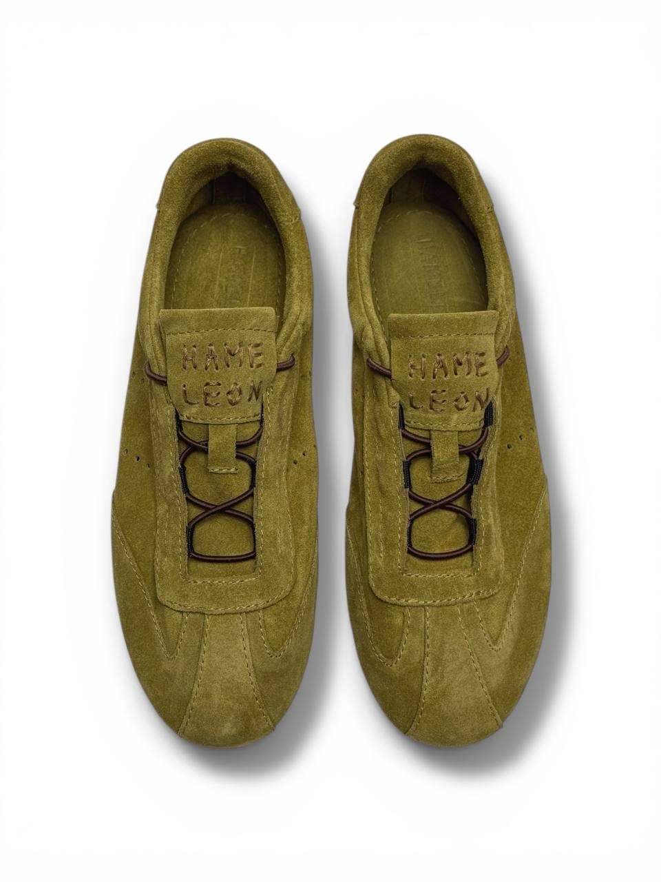 Pair of olive suede sneakers minimal style