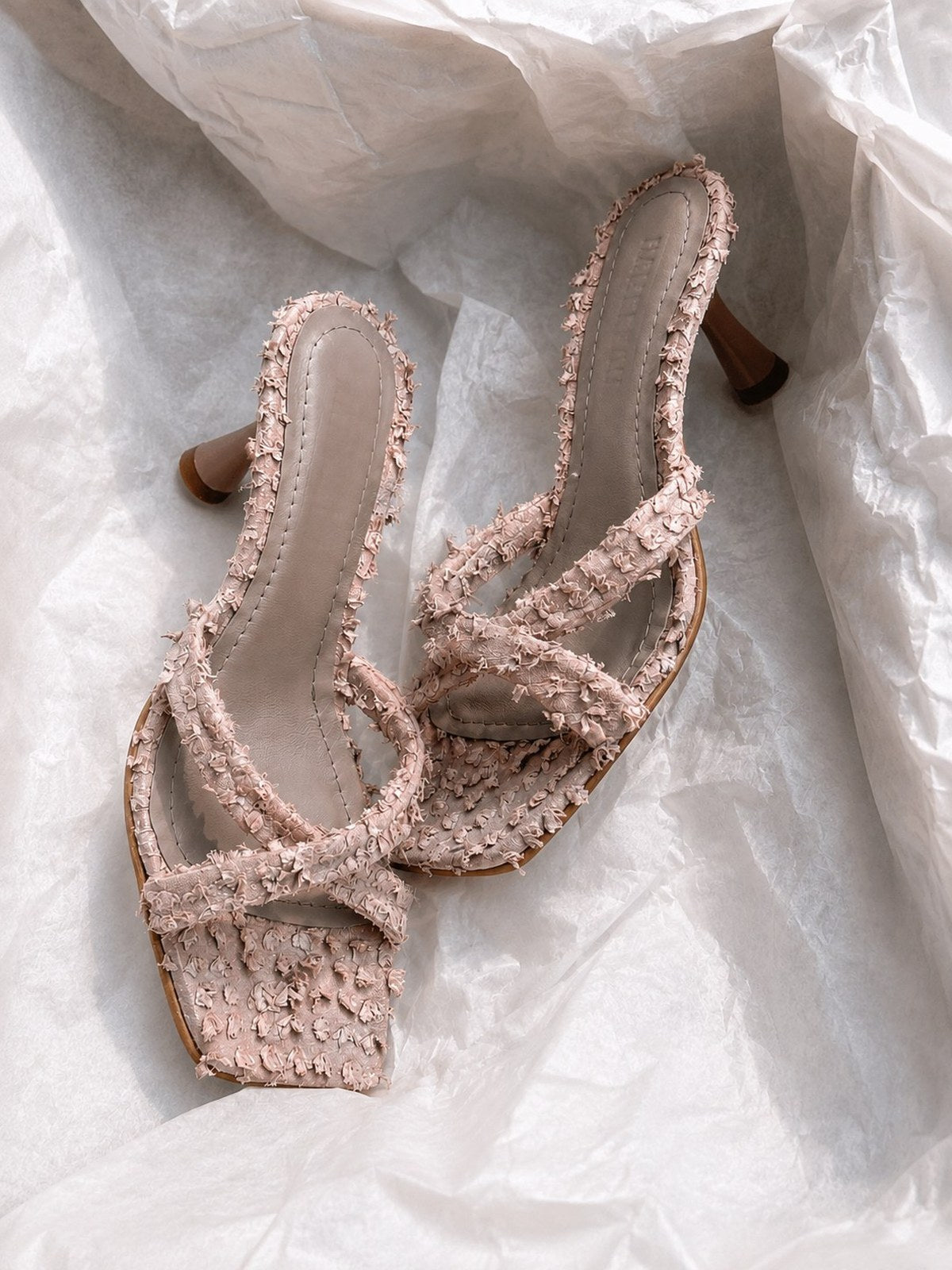 Blush mule with textured leather, cross straps and sculptural heel