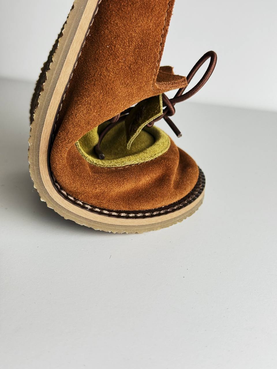 Flexible rubber outsole on handmade suede slides
