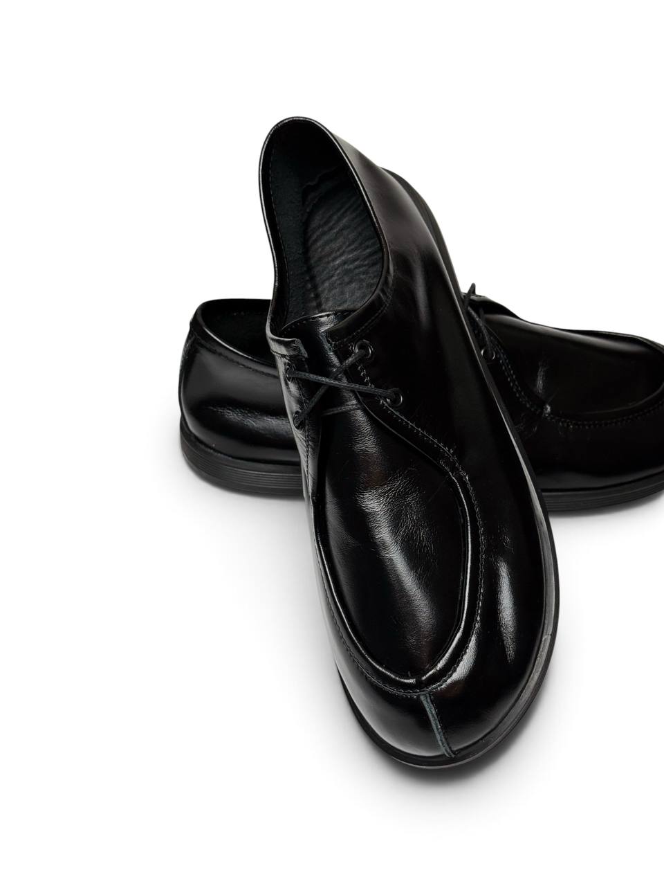 Close-up of black leather Onyx Walker shoe showing apron toe and lacing.