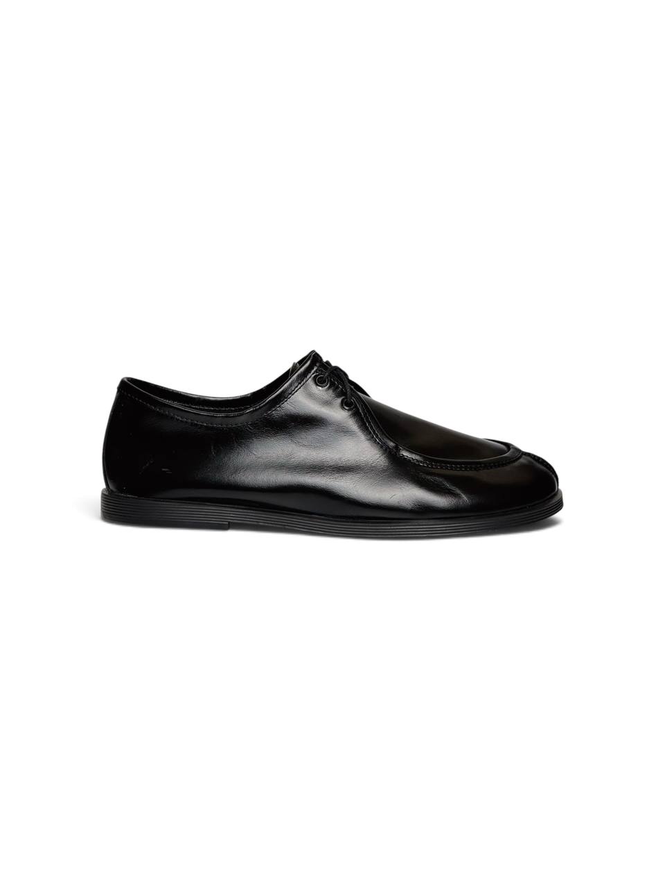 Side profile of black leather Walker shoe with low-profile flexible sole.