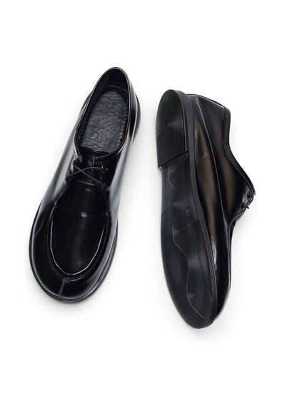 Walker shoes Onyx shown from above and underneath, revealing textured EVA sole.