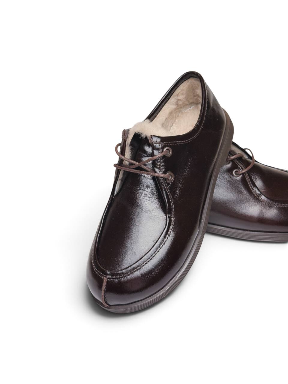 Close-up of Walkers Truffle showing glossy leather, lacing and moccasin stitching.