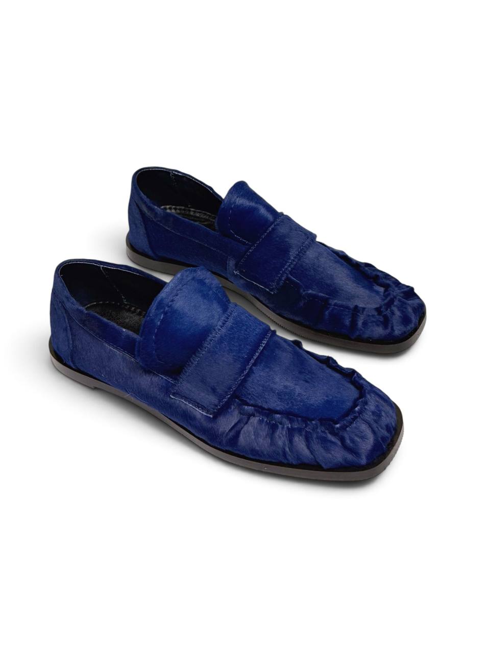 Cobalt blue leather loafers with a soft textured finish.