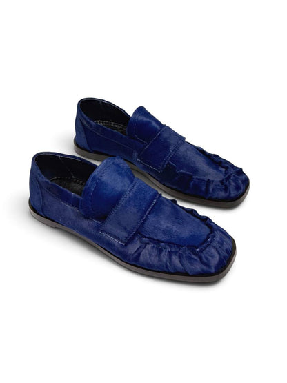 Cobalt blue leather loafers with a soft textured finish.