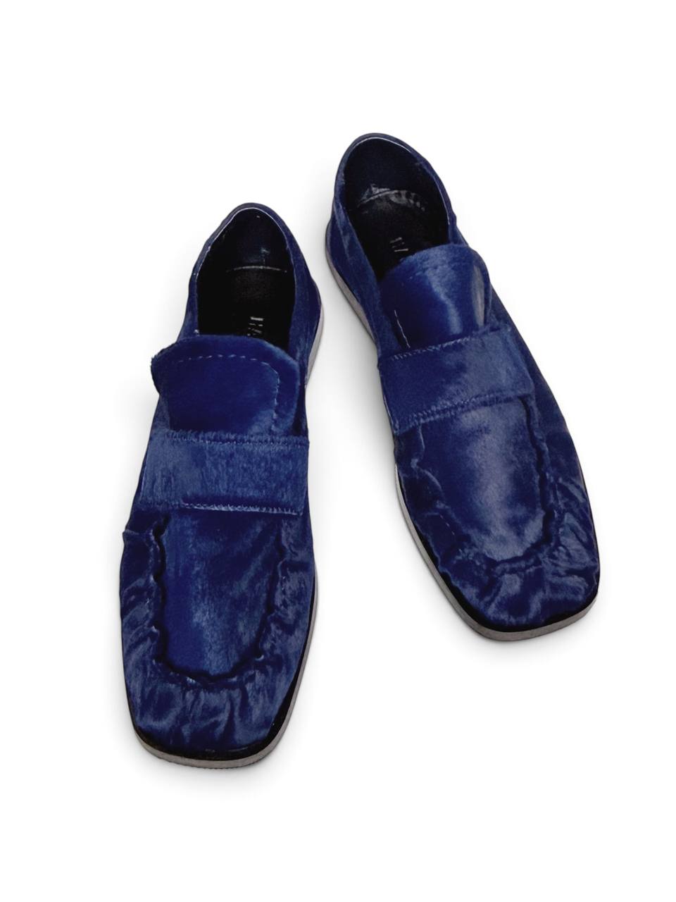 Top view of blue loafers with a rounded toe.