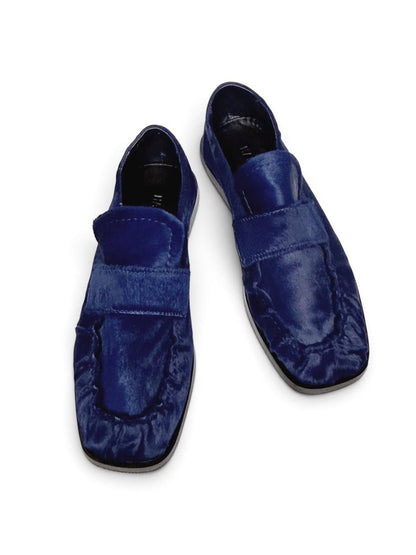 Top view of blue loafers with a rounded toe.