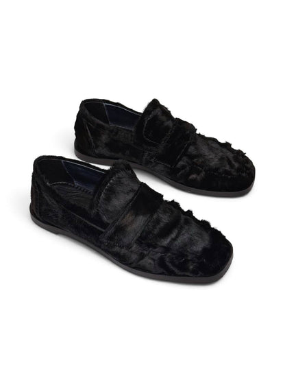 Pair of black hairy leather loafers with a distinctive textured finish.