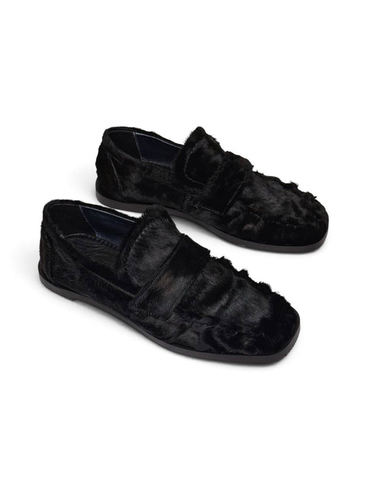 Pair of black hairy leather loafers with a distinctive textured finish.