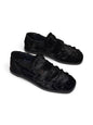 Pair of black hairy leather loafers with a distinctive textured finish.
