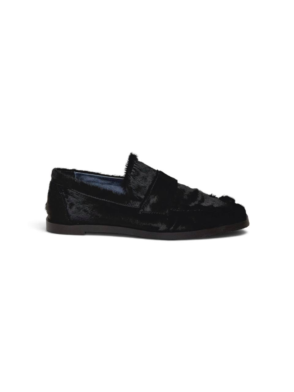 Side profile of a black hairy leather loafer with a slim sole.