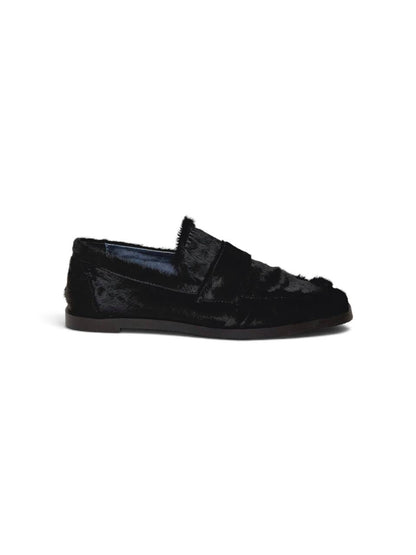 Side profile of a black hairy leather loafer with a slim sole.