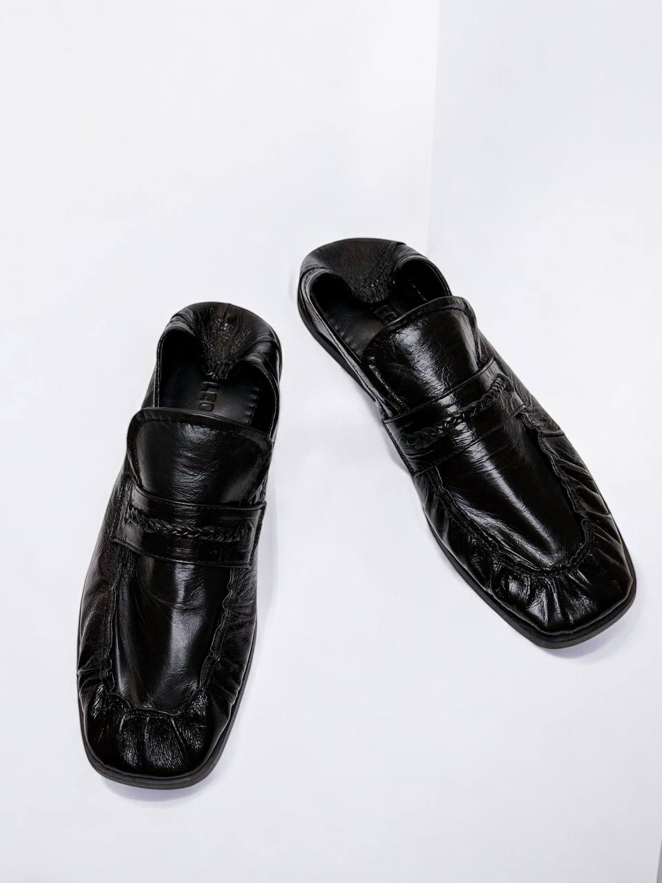 Minimalist black loafers with soft square toe