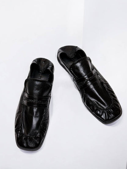 Minimalist black loafers with soft square toe