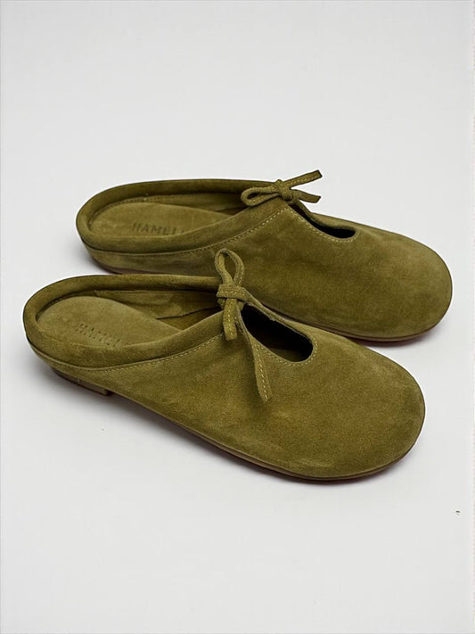 Handmade Mules Lulu Crocus crafted from soft olive suede, featuring a minimalist silhouette, open-back design, and adjustable lace detail