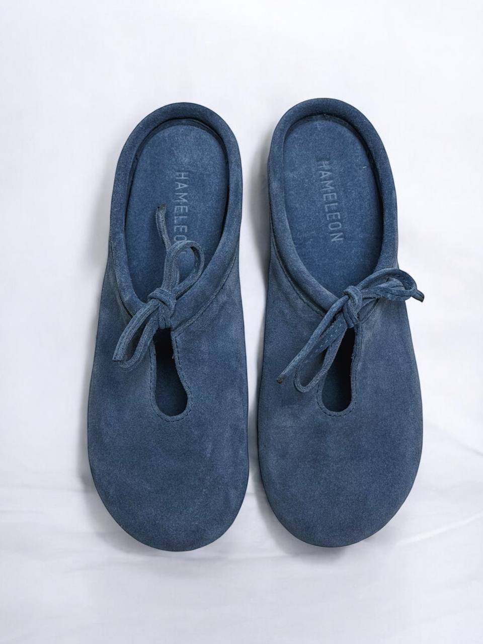 Top view of Mules Lulu Denim handcrafted from natural suede, featuring a rounded toe, suede footbed, and minimalist slip-on design