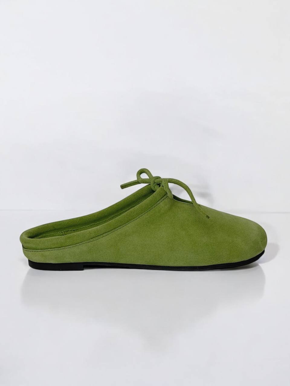 Side view of LULU Moss suede mules with minimalist silhouette