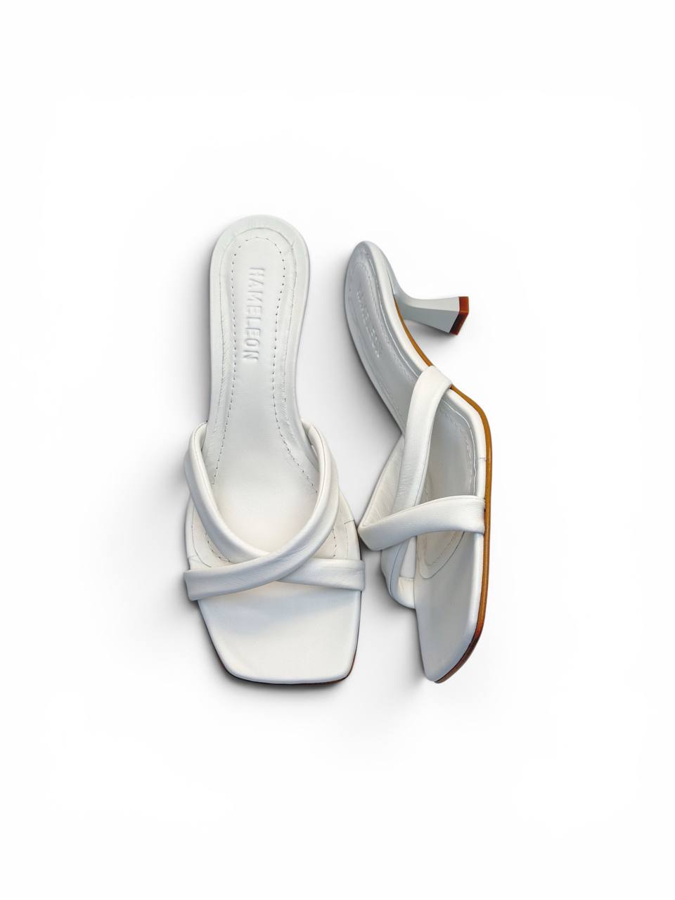 Pair of Selena Ivory artisan white leather mules with crossed straps