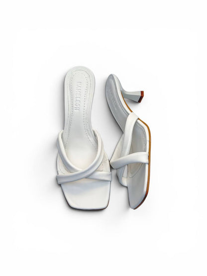 Pair of Selena Ivory artisan white leather mules with crossed straps