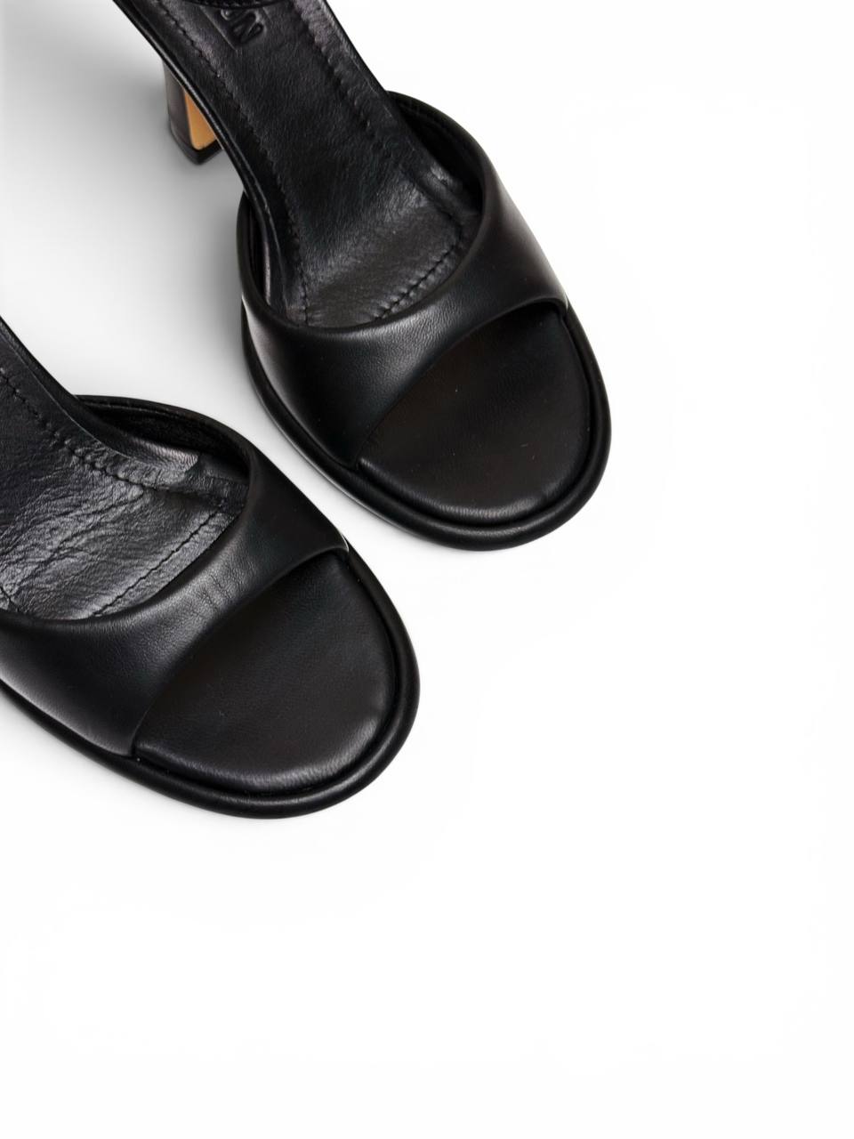 Close-up of black leather upper and open toe