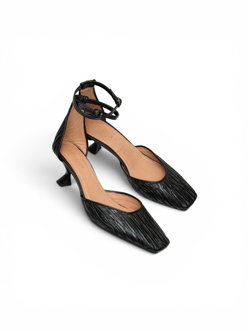 Onyx Pumps styled as minimalist black leather footwear for modern wardrobes