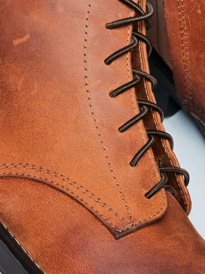 Close-up of dark laces on brown Crazy Horse leather boots