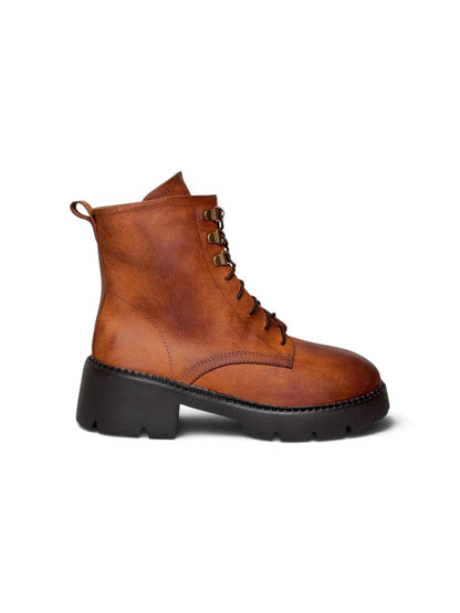 Side profile of cognac ankle boots with rugged EVA soles.
