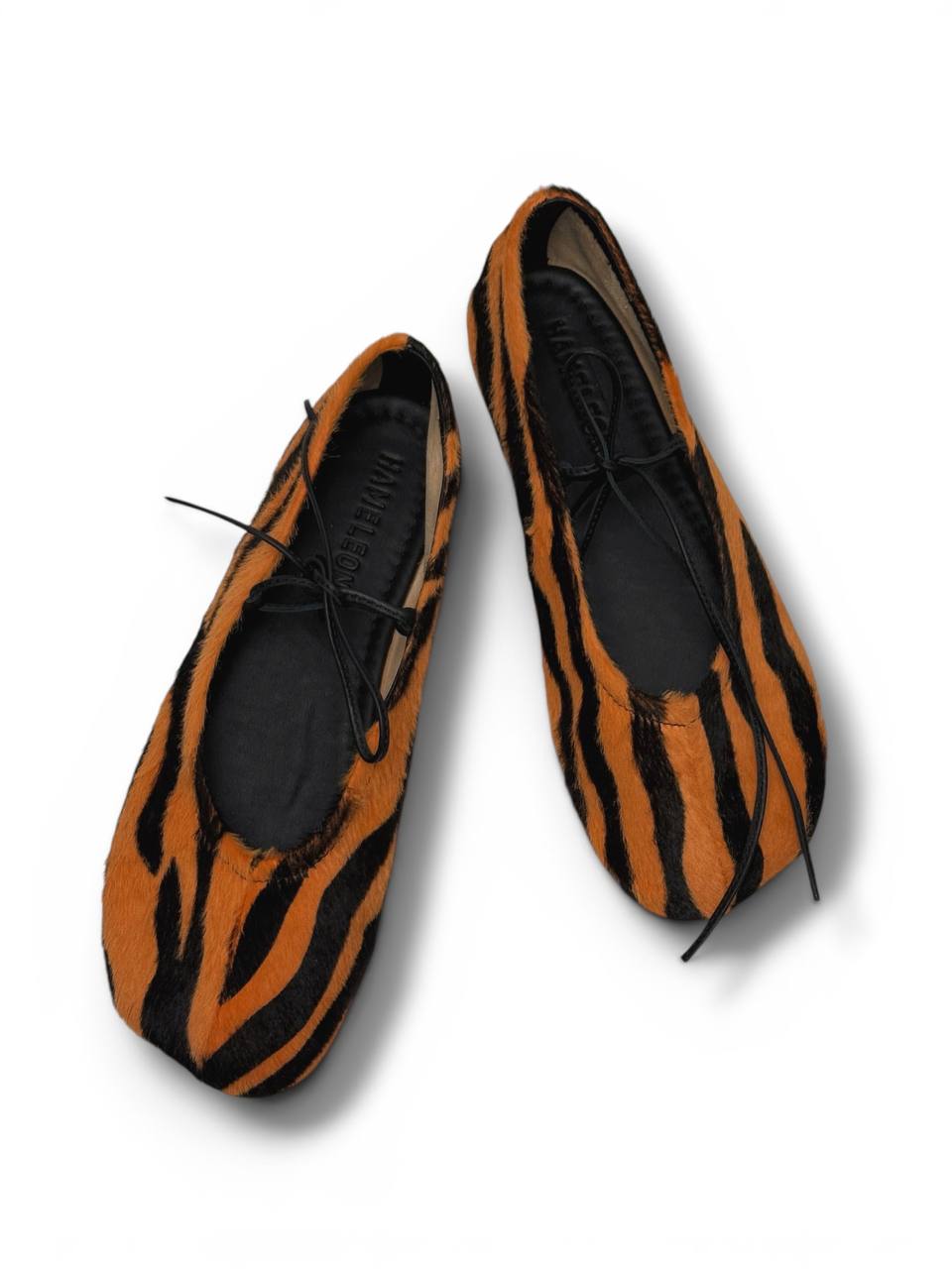Tiger print ballet flats top view minimal shape