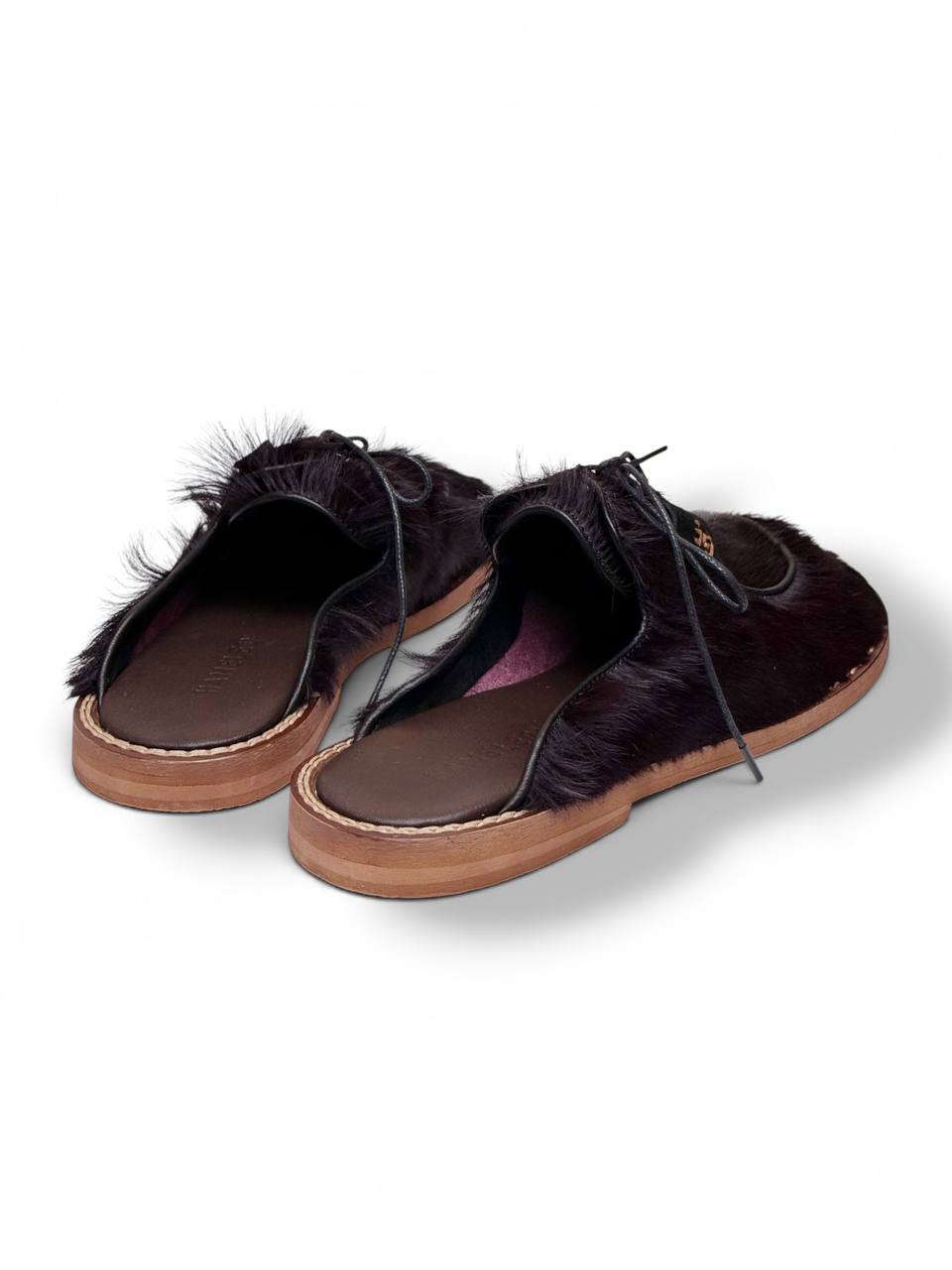 Rear view of handmade fur mules with leather lining