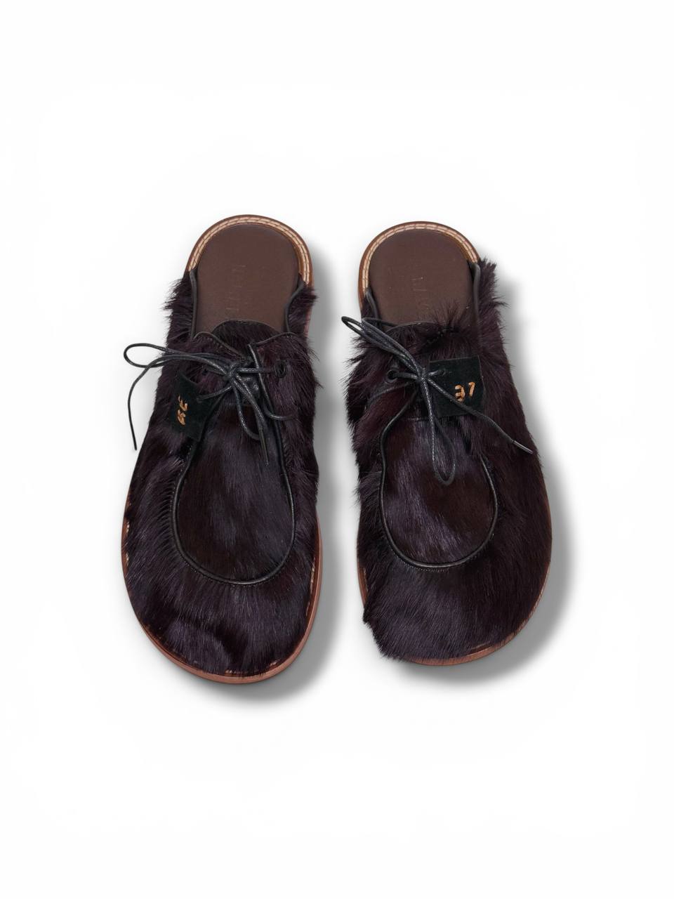 Top view of dark fur mules with adjustable laces
