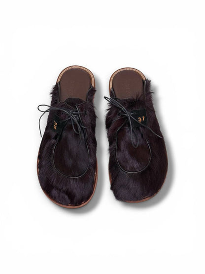 Top view of dark fur mules with adjustable laces