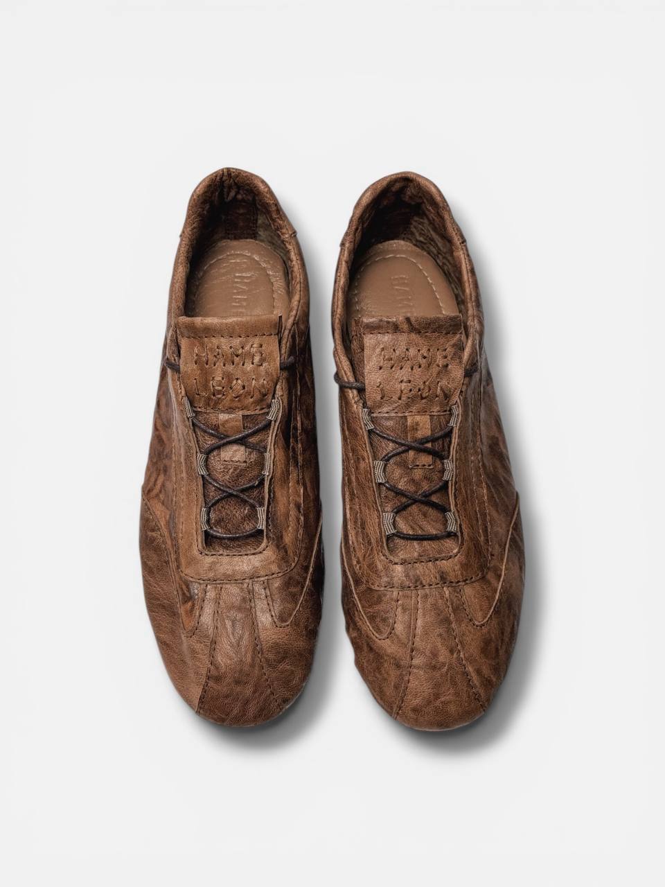 Brown leather sneakers top view lace detail