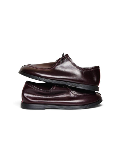 Burgundy leather walker shoes stacked to show slim handcrafted silhouette