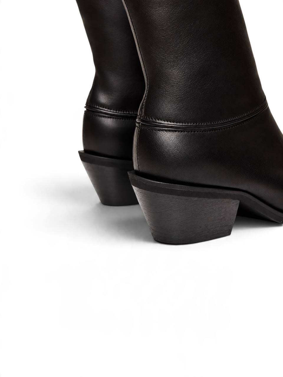 Close-up of black Western boots with sculpted block heels