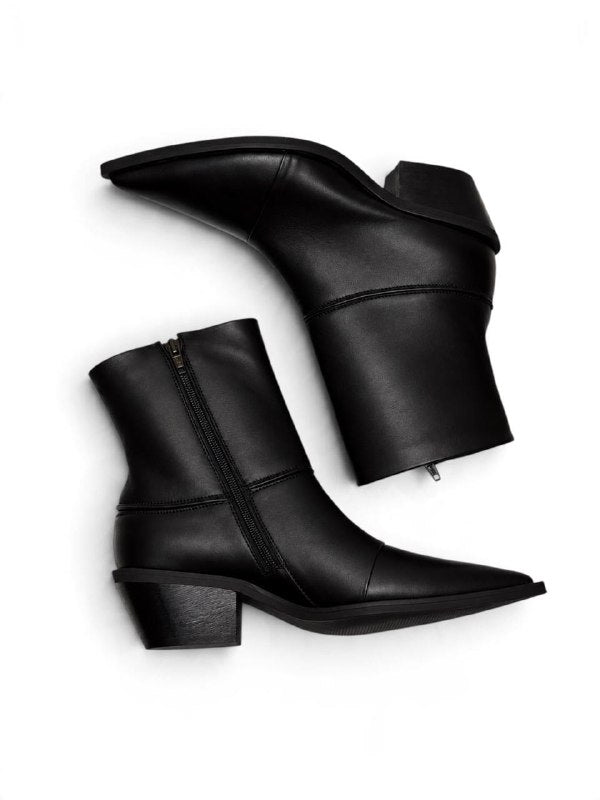Side view of black leather Western boots with zipper